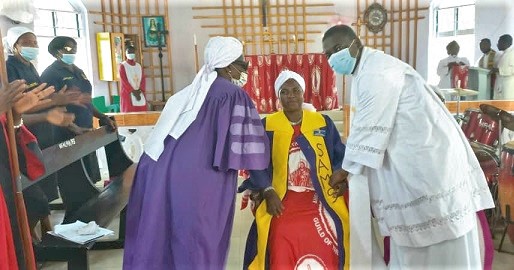  Grace Yamoah (middle) being inducted into office as the new Master Shepherd by Nelly Buaku Tettey (left), past National Master Shepherd. She is being assisted by Rev. Fr. Benjamin I. B. Amoah 